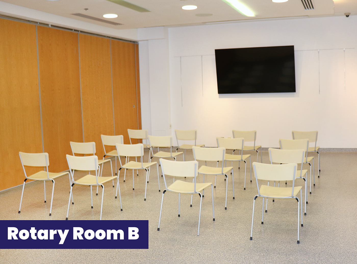 Example of Rotary Room B setup, presentation-style, with rows of chairs facing a TV screen on the wall.