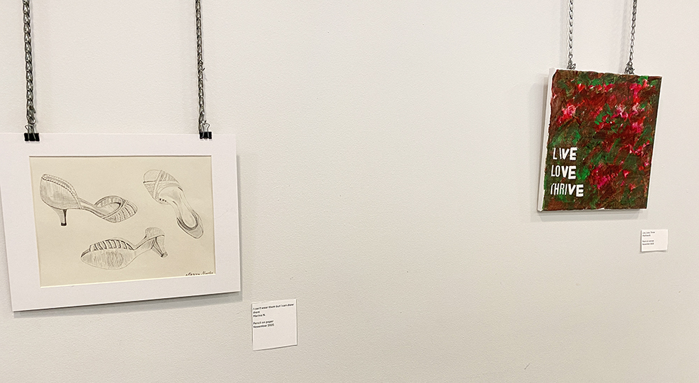 Two pieces of artwork on a wall in Rotary Room at Main Branch