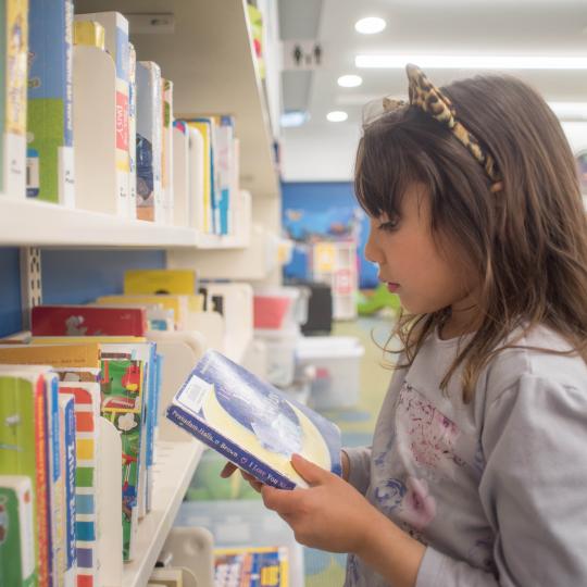 Child looking at books 