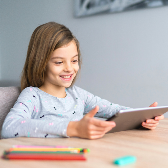 Child reading on tablet image